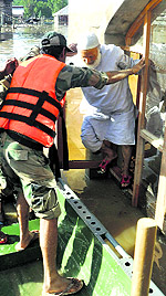 A 70-year-old man being evacuated from his house by the Army in Srinagar