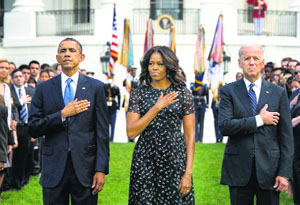 US marks 13th anniversary of 9/11: US President Barack Obama, First Lady Michelle Obama and Vice-President Joe Biden stand in silence for a moment at the White House in Washington