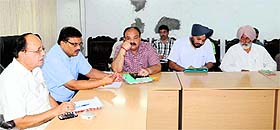 Mayor Bakshi Ram Arora (left) and MC Commissioner Pardeep Sabharwal (second from left) in a meeting with officials of the Municipal Town Planning Department at Maharaja Ranjit Singh Panorama in Amritsar on Friday.