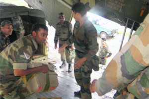 Army jawans load medicines and other supplies into aircrafts heading for Jammu and Kashmir in Bathinda on Friday.