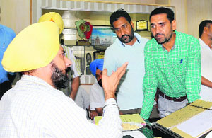 Teacher Jagsir Singh Sahota meets Zila Parishad chairman Gurpreet Singh Maluka in Bathinda on Friday.