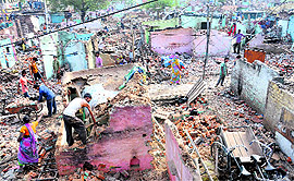 People try to retrieve valuables from the debris of their demolished shanties at Madrasi Colony in Chandigarh on Friday