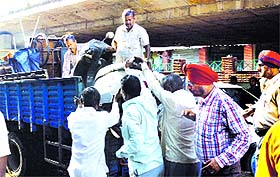 MC officials remove temporary encroachments from the Bhadaur House area in Ludhiana on Friday. 
