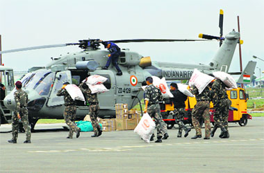 Air Force men load relief material into a helicopter in Srinagar on Friday.