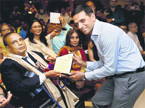 Dravid felicitates Murlikant Petkar, Indias first gold medallist at the paralympics, in Mumbai.