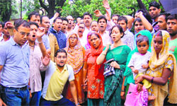 Local people and BJP activists protest against the broadening of the Ganga canal being carried out by the Uttar Pradesh Irrigation Department in Haridwar on Friday. Tribune photo: Rameshwar Gaur