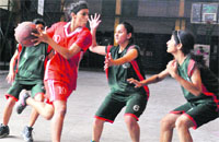 Players try to block a cager in a match in the 10th Gardener Silver Jubilee Inter School Basketball Tournament in Dehradun on Friday. Tribune photo: Abhudaya Kotnala