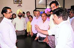 Parents and students of Chintpurni Medical College interact with Cabinet Minister Anil Joshi in Amritsar on Saturday