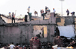 Labourers demolish the old building at Sri Guru Ramdas Jee International Airport in Amritsar on Saturday