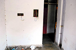 Loose wires hanging in a room at a hostel