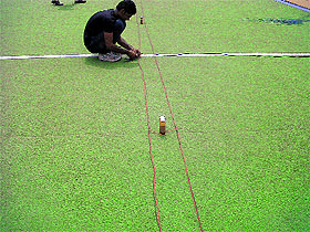 A workers installs Chinese fireworks at the Hockey Stadium of Government Rajindra College ahead of World Kabaddi League.