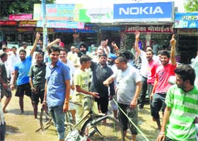 Shopkeepers block traffic on the Janata Bhawan Road to protest waterlogging in Sirsa on Saturday