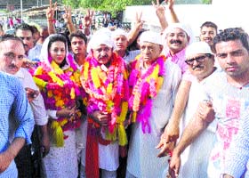 Doon MLA Ram Kumar, his wife Nidhi and father and former MLA Lajja Ram outside the Haripur gurdwara in Solan on Saturday