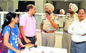 cops interact with the employees of Gramin Bank at Wariana village in Jalandhar on Saturday.