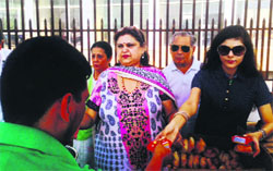 Prominent women of Jammu distribute eatables among flood-hit. A Tribune Photograph