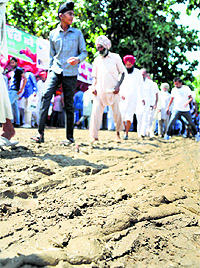 Visitors cautiously tread on the mela ground on the PAU campus during Kisan Mela