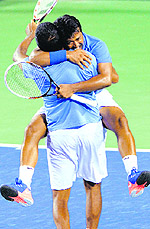 Leander Paes hugs Rohan Bopanna after winning the mens doubles match in Bangalore on Saturday