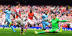 Arsenals Jack Wilshere scores an equaliser past Manchester Citys goalkeeper Joe Hart during their English Premier League match in London on Saturday