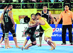 Punjab Thunders stopper (in black) tries to stop a Yo Yo Tigers raider during their World Kabaddi League match in Bathinda on Saturday