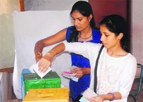 Girls cast their ballot during the students council poll at DAV College in Dehradun on Saturday