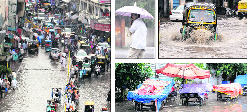 Water water everywhere: Residents make their way through a waterlogged road after a spell of rain in Amritsar on Sunday.