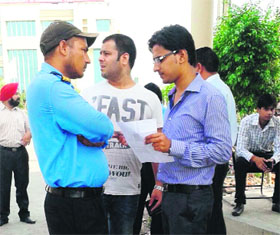 A student argues with an official when he was denied entry to the examination hall in Amritsar on Sunday