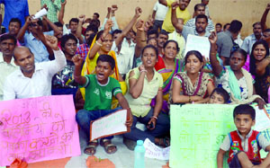 Residents of Aaya Nagar sit on a dharna at Jantar Mantar in New Delhi on Sunday.