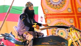 Dera Sacha Sauda head Gurmeet Ram Rahim Singh rides a fabricated motorbike used in his upcoming film in Sirsa on Sunday.