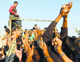 Volunteers distribute relief material among flood survivors in Srinagar on Sunday. 