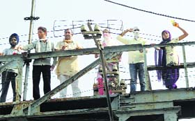 Teacher Eligibility Test Pass Unemployed Union members stand on the railing of head works bridge