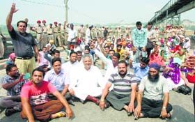 Another group of protesters holds a dharna on the Ropar-Jalandhar road at Ropar on Sunday