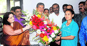 Chief Minister Harish Rawat honours Savita Gurung in Dehradun on Sunday. 