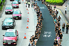 Demanding genuine democracy: Demonstrators march during a pro-democracy rally in Hong Kong on Sunday. 
