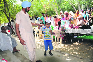 Parents bring their children to a medical assessment camp for kids with special needs at the Government Elementary School in Bathinda on Monday.