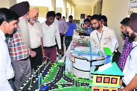Students explain the functioning of a model during the Engineers Day celebrations at Guru Kashi University in Talwandi Sabo on Monday.