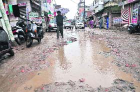 Rainwater accumulates on an uncarpeted road at the main bazaar of Balongi village near Mohali. MLA Balbir Singh Sidhu has alleged that certain panchayat members in connivance with government officials embezzled money meant for development works