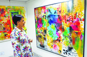 A visitor admires the artworks on display at Kalagram