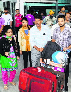 Persons evacuated from flood-ravaged Kashmir arrive at the Amritsar airport on Monday.