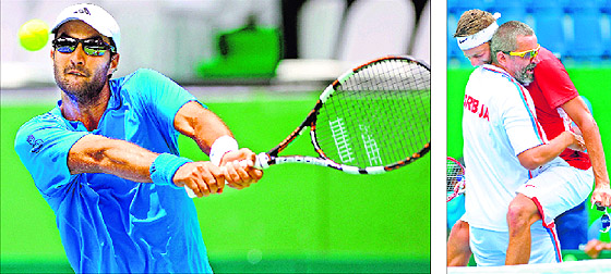 Yuki Bhambri returns to Filip Krajinovic; and Serbian team captain Bogdan Obradovic lifts Krajinovic after the Davis Cup match in Bangalore on Monday. Krajinovic won 6-3 6-4 6-4.