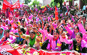 Asha workers hold a demonstration outside the secretariat in Dehradun on Monday. 