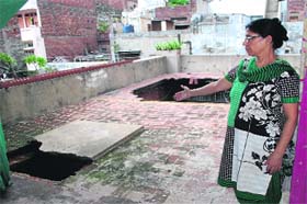Neelam Mehra, owner of the house, shows its damaged portion in Amritsar