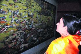 Reliving history: Union Human Resource Development Minister Smriti Irani looks at a painting of the martyrs at the Jallianwalla Bagh in Amritsar on Tuesday