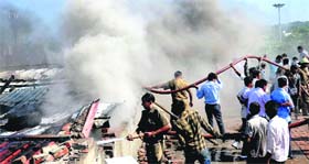 Firefighters in action at a car accessory showroom in Ram Darbar, Industrial Area, Phase II, Chandigarh, on Tuesday.