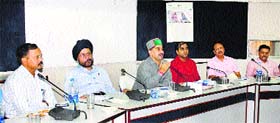 Kewal Pathania, vice-chairman, Forest Corporation, presides over a meeting of forest officials in Una on Tuesday.
