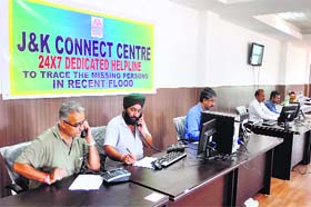 Employees receive telephone calls to lodge missing person reports at the Connect centre in Jammu on Tuesday