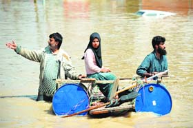 A file photograph of locals transporting a stranded girl on a makeshift raft through the floodwaters in Srinagar