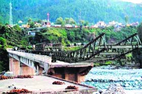 Personnel of the Engineer Regiment work on constructing a Bailey bridge in the Kotranka tehsil of the Jammu region