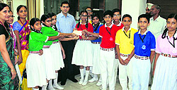 Students and staff of Decent Public School hand over a cheque for ~50,000 to DC Rajat Aggarwal in Ludhiana