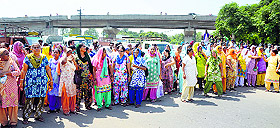 Anganwadi workers block Malerkotla Road in Ludhiana on Tuesday