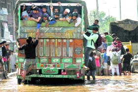 People board a truck to move to safer places in Srinagar on Tuesday